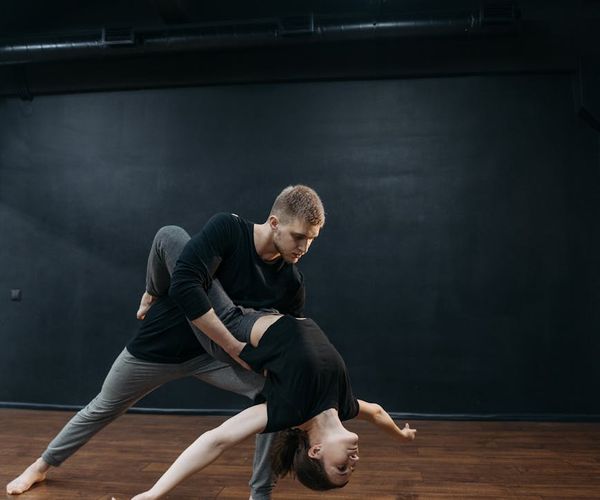 Man holding a difficult balance pose, showing concentration and stability.